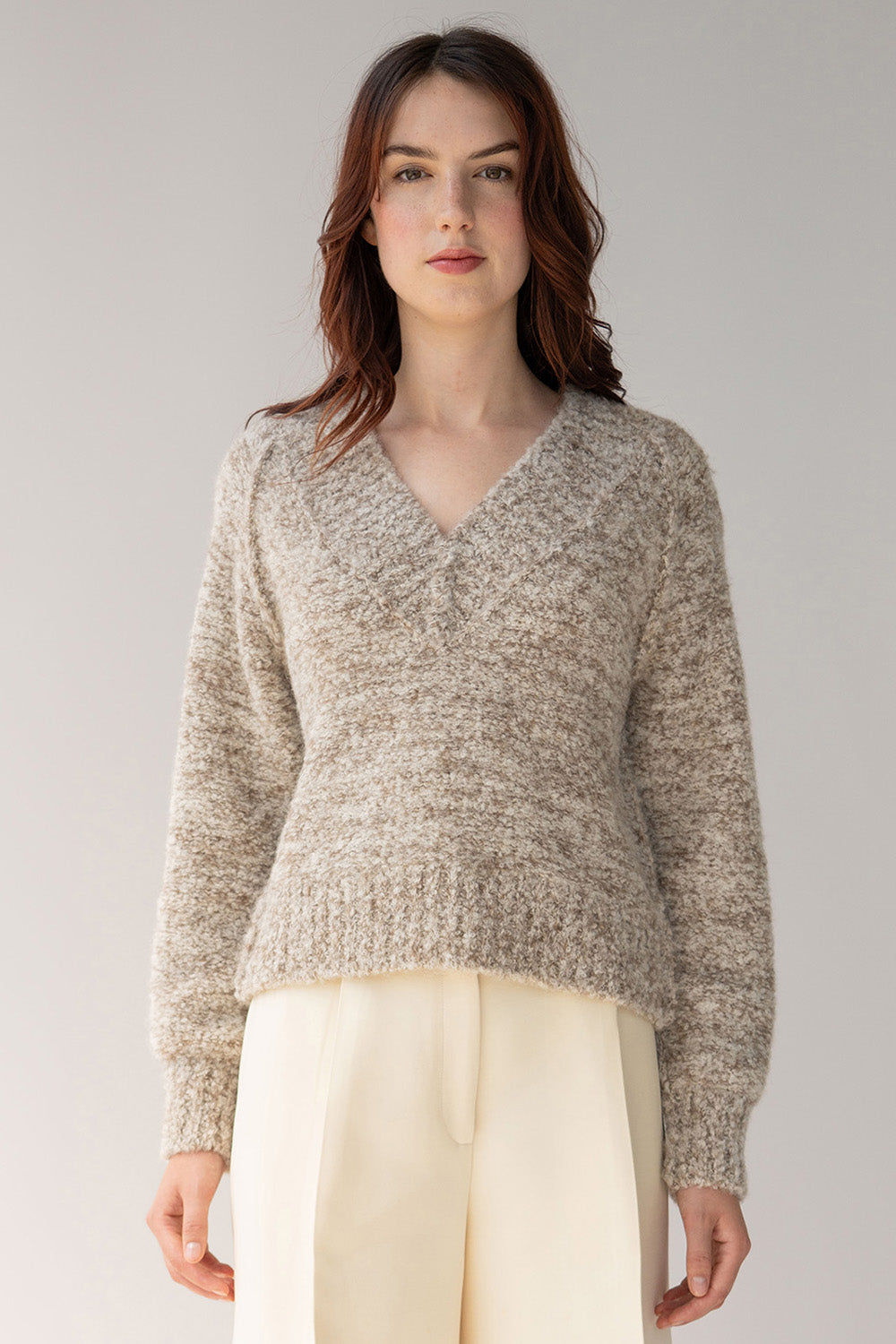 Oat ivory alpaca pullover features a low v in front knitted in soft texture boucle yarn