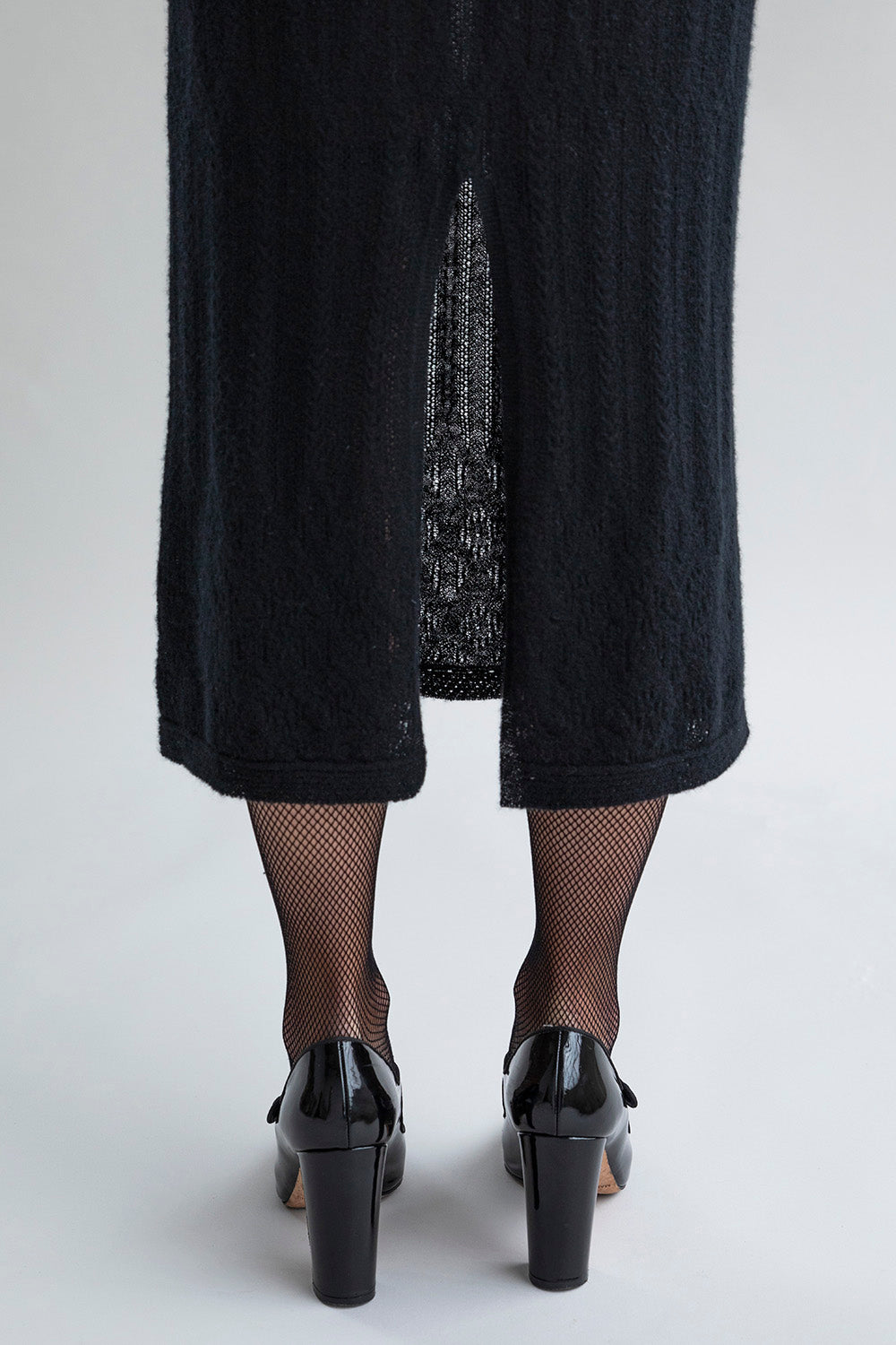 Detail of the center back slit as seen on the Margot Dress in black.