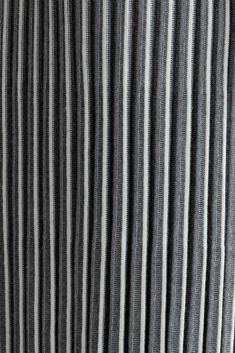 Super close-up shot of the contrasting vertical stripes on the Adeline Skirt, highlighting the intricate detailing and the soft blend of baby alpaca, silk, and nylon.