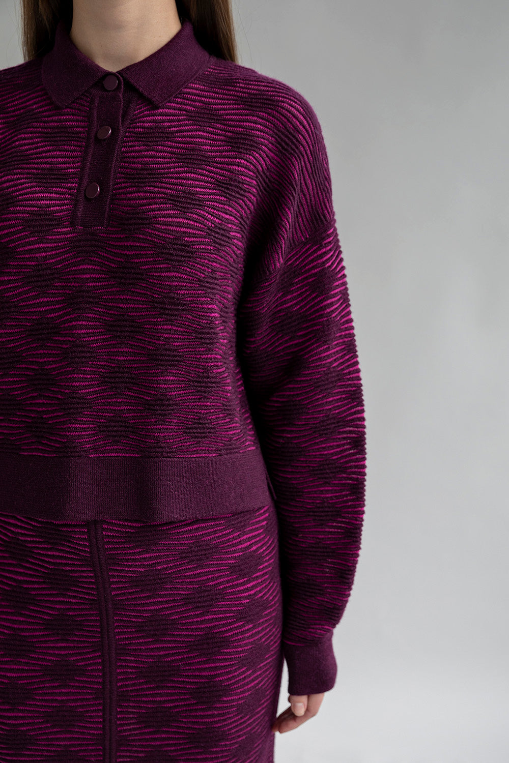 Close-up of three aubergine buttons on the Amelie Polo sweater.