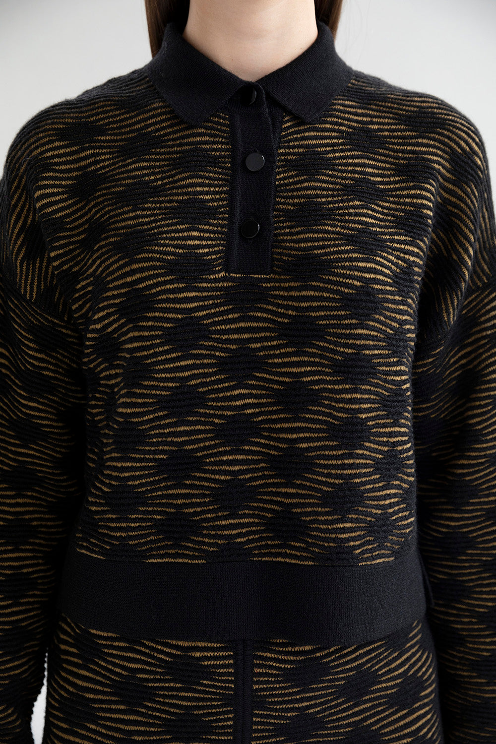 Close-up of three black buttons on the Amelie Polo sweater.