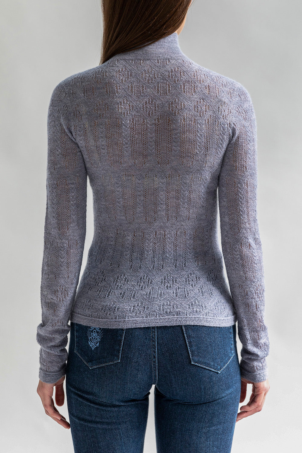 Full back view of a model wearing a grey lace pointelle lightweight pullover sweater.