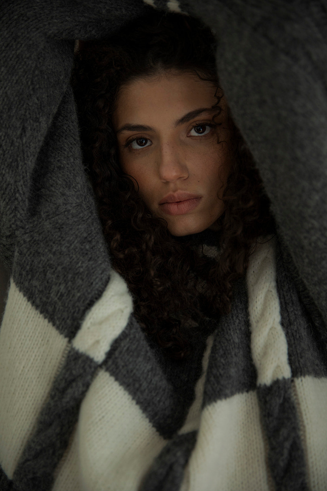 Knitted with lofty yarn, model wears cozy lightweight pullover.