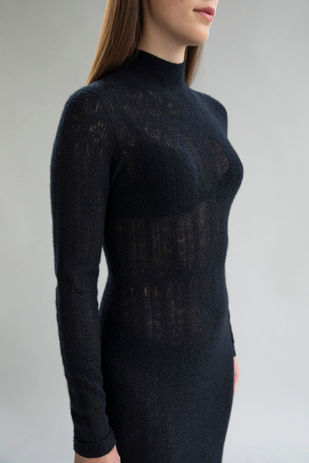 Close-up of the lightweight black Margot Dress, ethically made from 100% cashmere, showcasing elegant pointelle detailing.