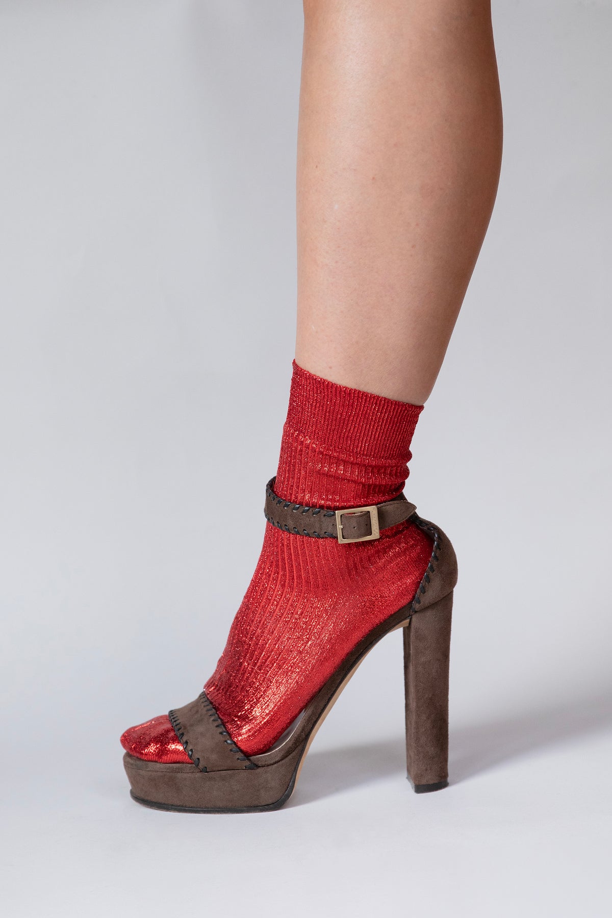Close-up of the ribbed texture and laminated sheen on the red Lumine silk socks