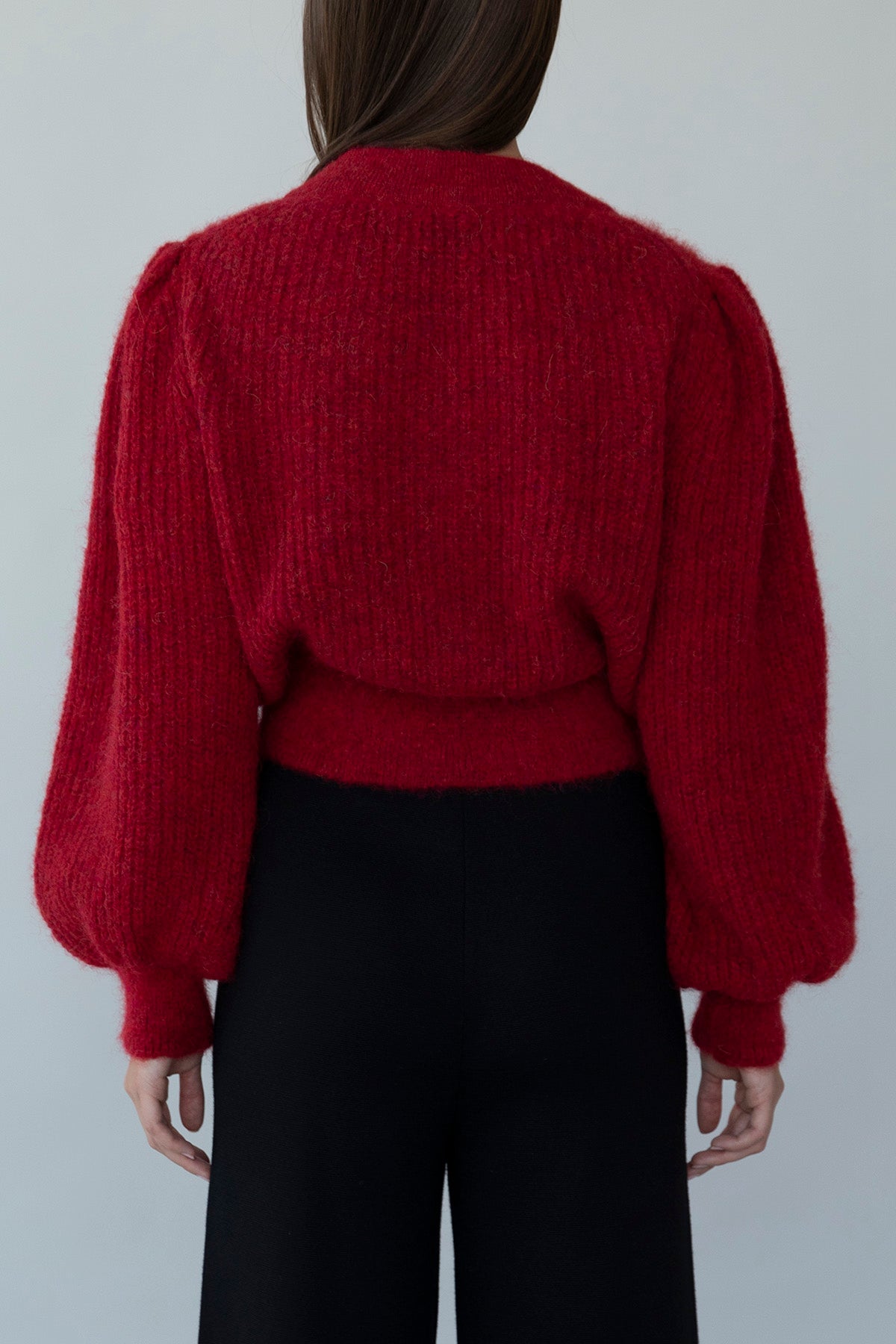 Back view of crimson red Meredith Peck collaboration cardigan, showcasing clean lines and a flattering fit.