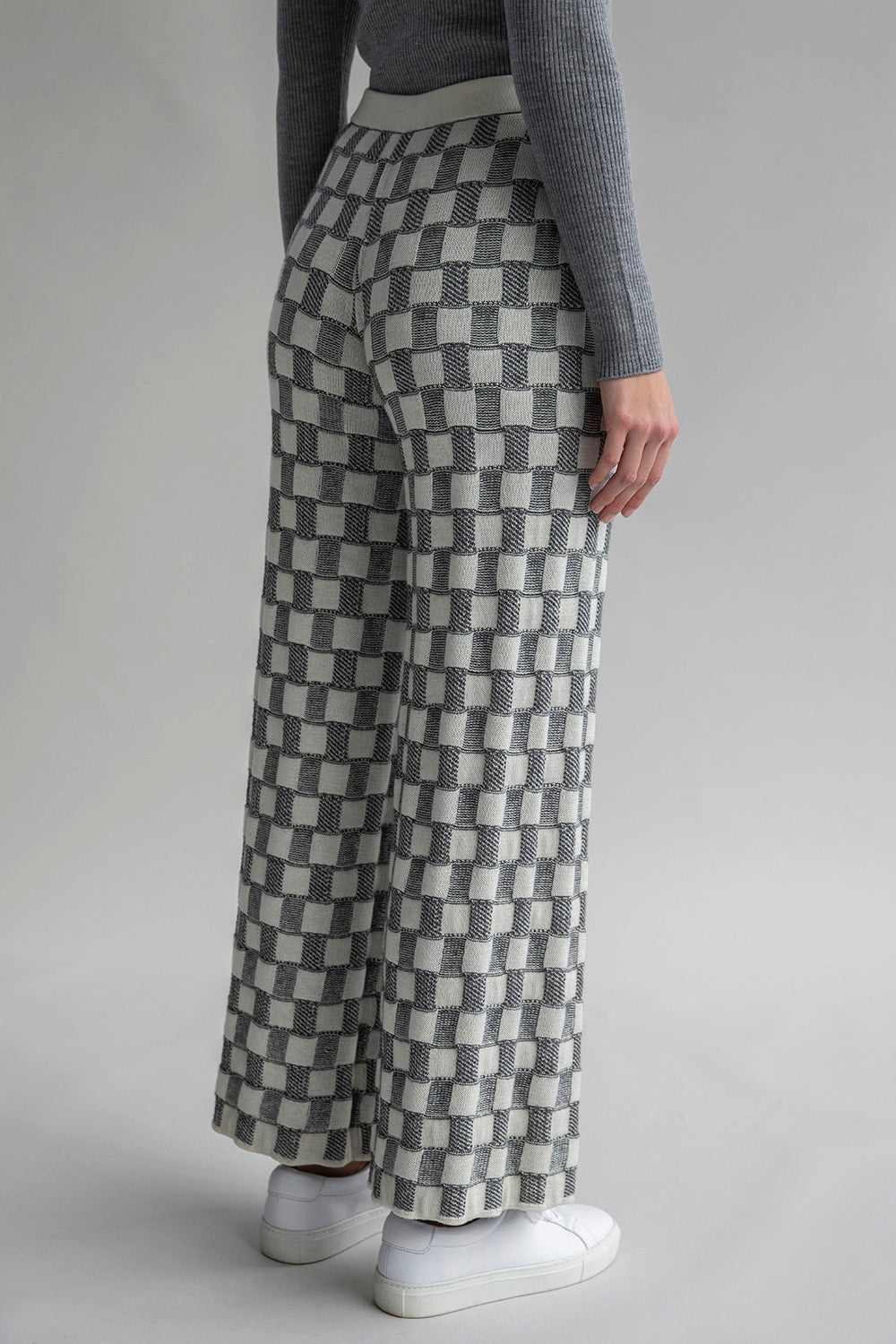 Side view of Zoe Trousers in the lighter grey ivory colorway, featuring a mid-rise fit.