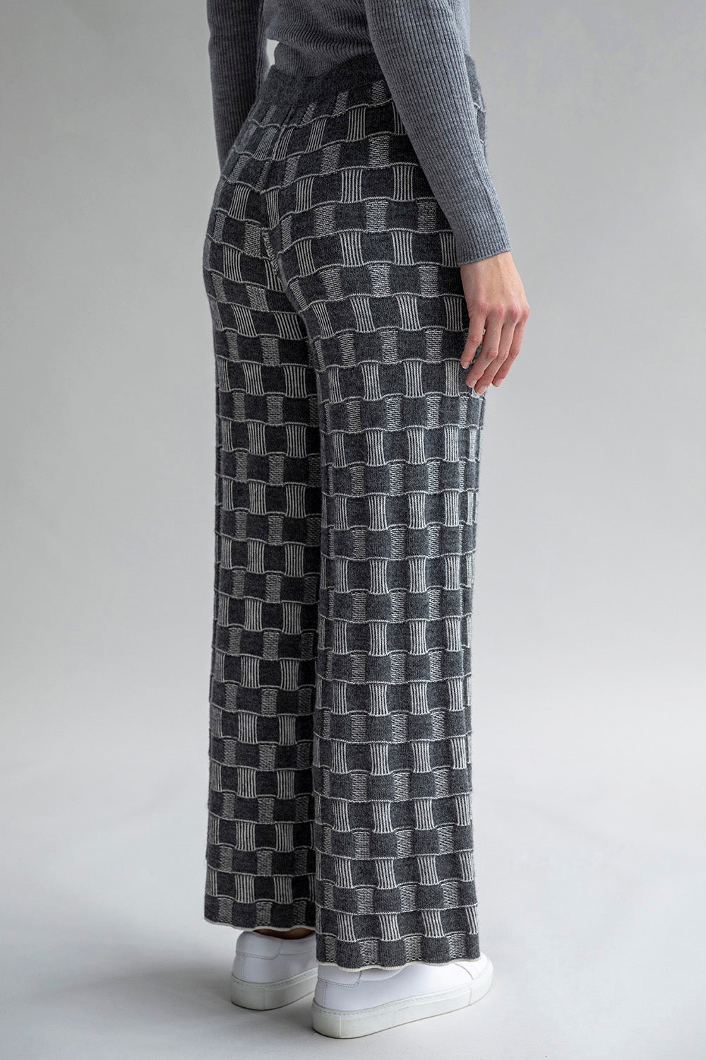 Side view of Zoe Trousers with a mid-rise fit darker grey ivory colorway. Waistband is dark grey.